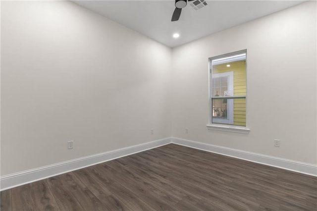 spare room with dark hardwood / wood-style floors and ceiling fan