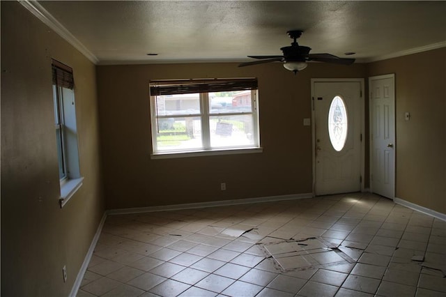 tiled entryway with ceiling fan and ornamental molding