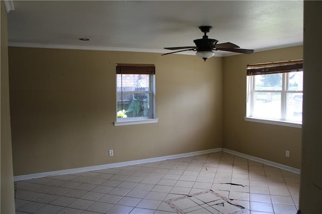 spare room with crown molding, light tile patterned flooring, ceiling fan, and plenty of natural light