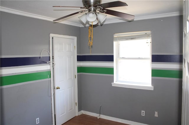 empty room with crown molding, wood-type flooring, and ceiling fan