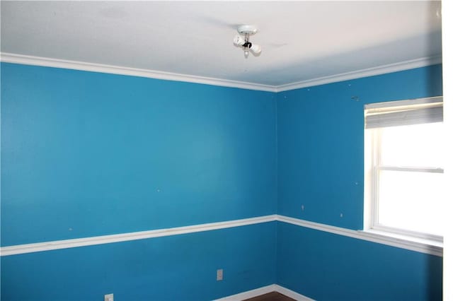 empty room featuring crown molding