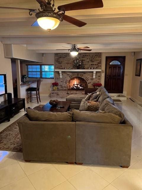 tiled living room featuring ornamental molding and ceiling fan