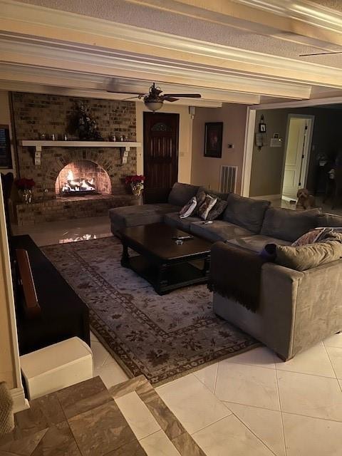 home theater room featuring crown molding, tile patterned flooring, a fireplace, and ceiling fan