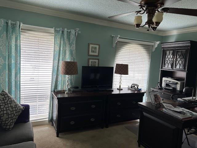 carpeted home office with crown molding, a textured ceiling, and ceiling fan