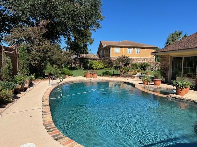 view of swimming pool with a patio