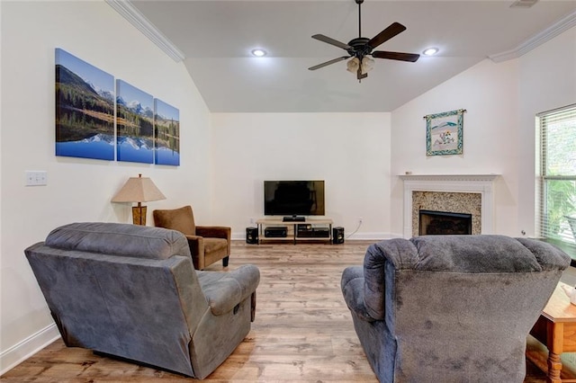 living room featuring ceiling fan, hardwood / wood-style flooring, ornamental molding, and lofted ceiling