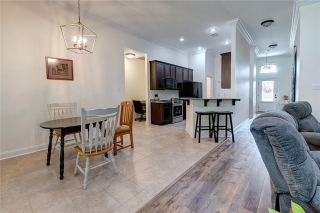 dining area with an inviting chandelier, light hardwood / wood-style flooring, and ornamental molding