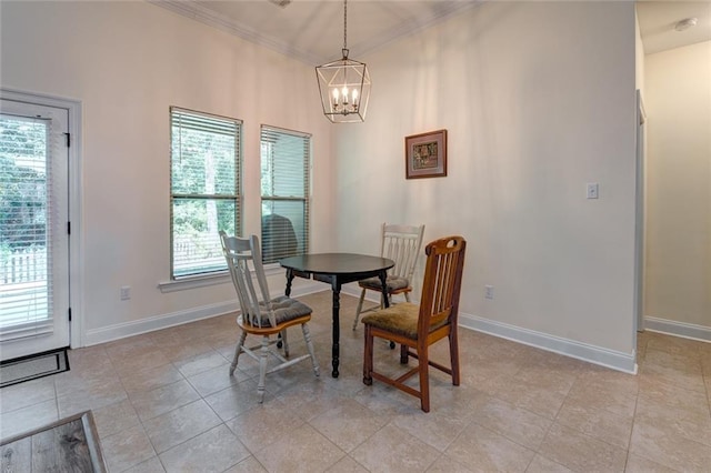 tiled dining space featuring ornamental molding and a chandelier