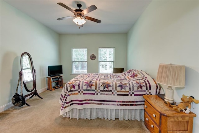 bedroom with ceiling fan and light colored carpet