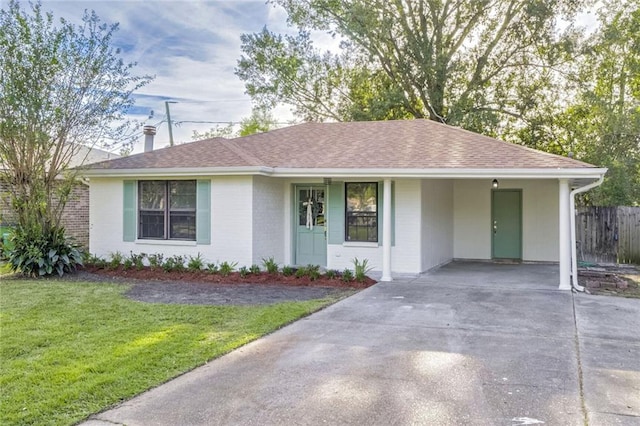 ranch-style house with a carport and a front yard