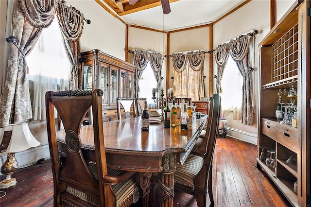 dining space featuring a wealth of natural light, crown molding, and dark hardwood / wood-style floors