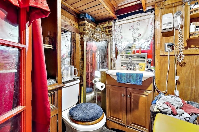 bathroom with vanity, toilet, and wooden ceiling