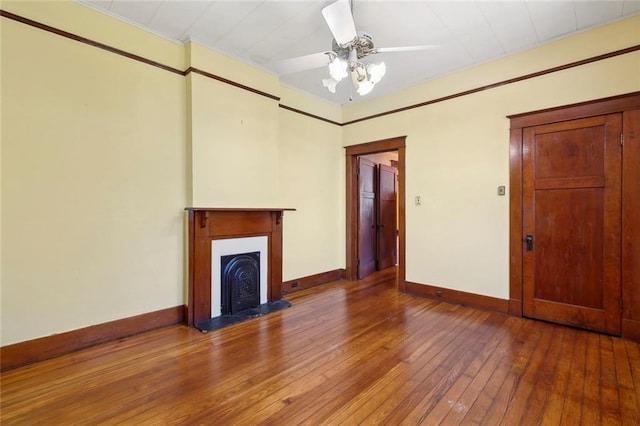 unfurnished living room with hardwood / wood-style flooring and ceiling fan