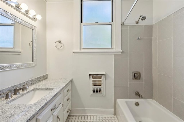 bathroom featuring tile patterned floors, heating unit, vanity, and tiled shower / bath combo