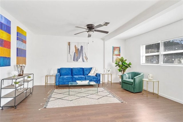 living area featuring wood-type flooring and ceiling fan