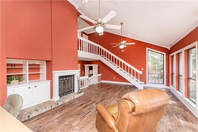 64 Fairway View Dr Unit 1, Hammond, LA 70401 - living room featuring stairway, a brick fireplace, crown molding, a ceiling fan, and wood finished floors