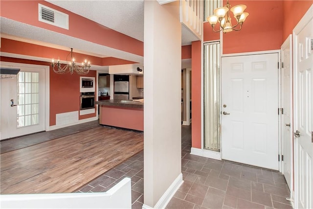 64 Fairway View Dr Unit 1, Hammond, LA 70401 - entryway with baseboards, visible vents, and an inviting chandelier
