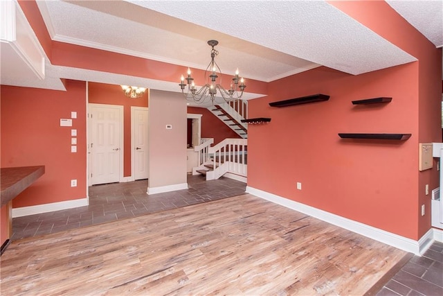 64 Fairway View Dr Unit 1, Hammond, LA 70401 - interior space featuring stone tile floors, a textured ceiling, a chandelier, baseboards, and stairs