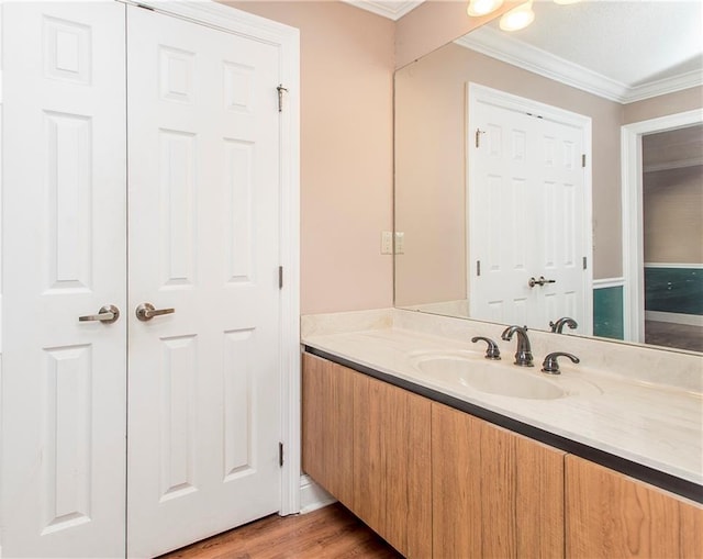 64 Fairway View Dr Unit 1, Hammond, LA 70401 - bathroom with wood finished floors, crown molding, and vanity
