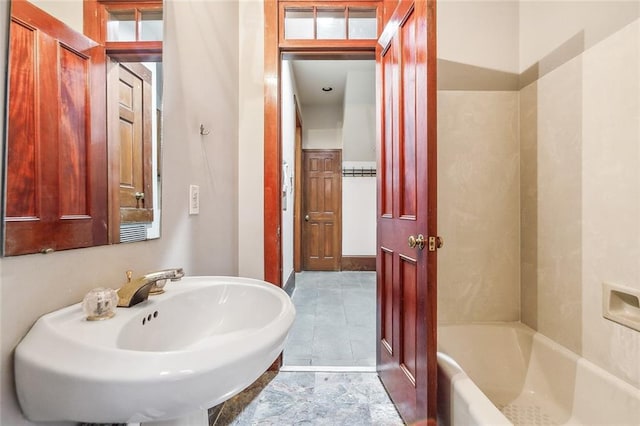 bathroom with sink, tile patterned floors, and a bathtub