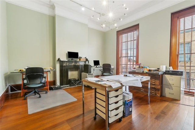 office area with a notable chandelier, hardwood / wood-style flooring, ornamental molding, and plenty of natural light