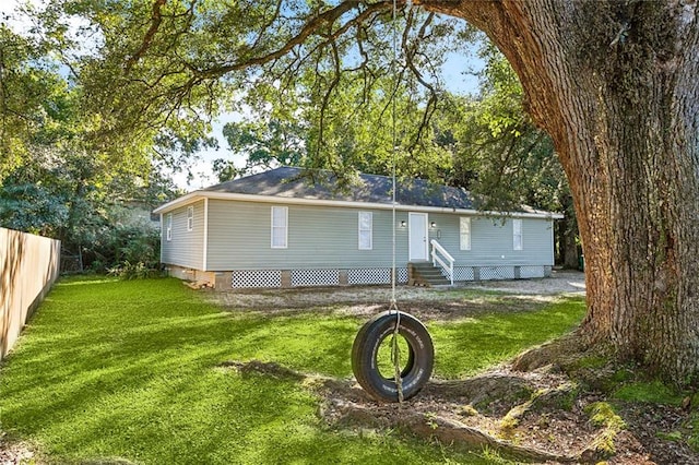 rear view of house featuring a yard