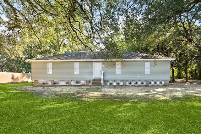 rear view of property featuring a yard