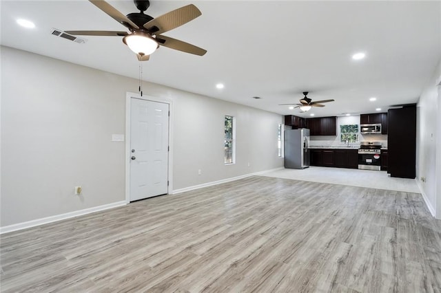 unfurnished living room with ceiling fan and light hardwood / wood-style flooring