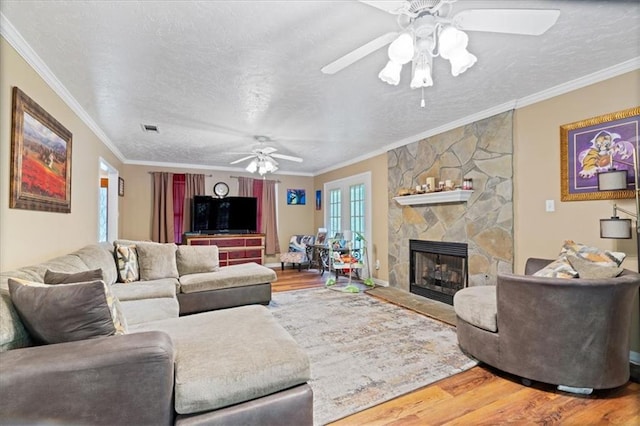 living room featuring ceiling fan, wood-type flooring, and ornamental molding