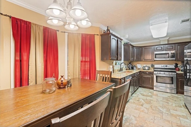 kitchen featuring an inviting chandelier, sink, ornamental molding, dark brown cabinets, and appliances with stainless steel finishes