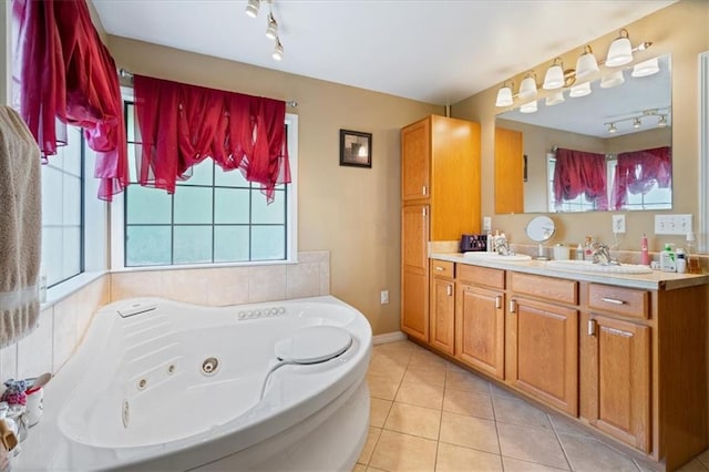 bathroom featuring track lighting, vanity, a tub to relax in, and tile patterned floors