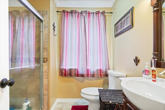 bathroom featuring a shower with door, vanity, crown molding, tile patterned floors, and toilet