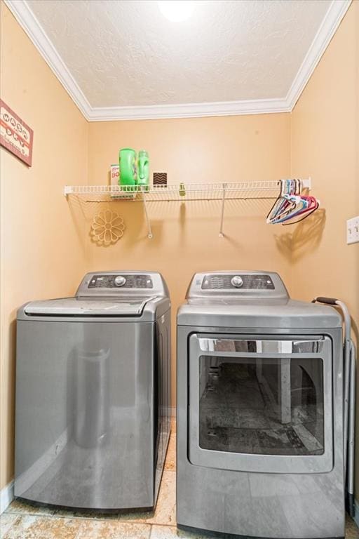 washroom with separate washer and dryer, a textured ceiling, and crown molding