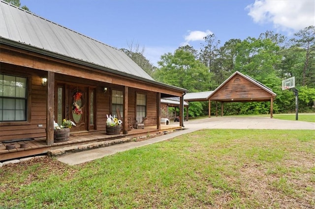 view of yard with a porch and a carport