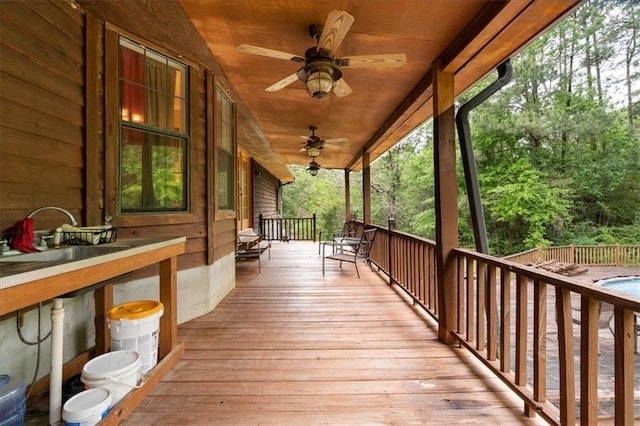 wooden terrace featuring ceiling fan