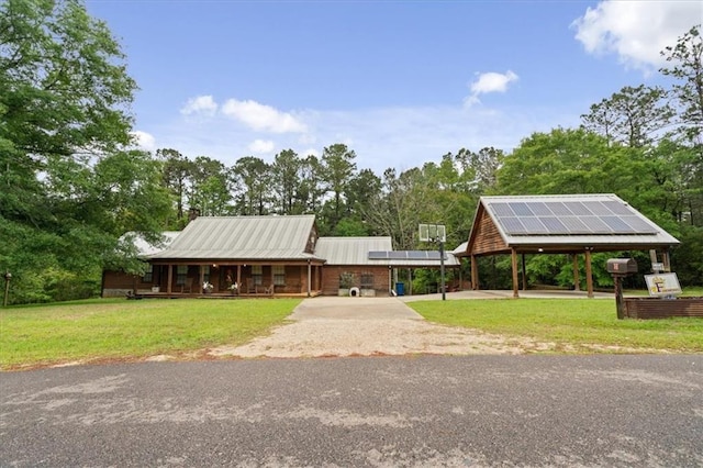 view of front facade featuring solar panels and a front yard