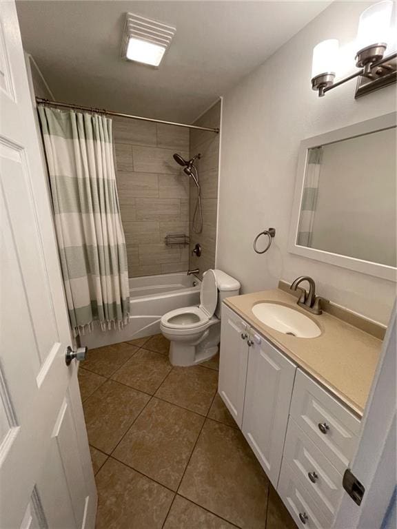 full bathroom featuring vanity, shower / tub combo with curtain, toilet, and tile patterned flooring