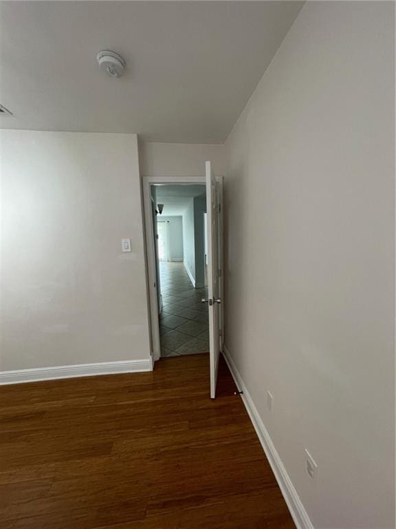 corridor featuring dark wood-type flooring