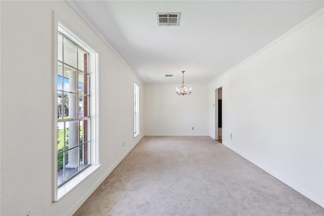 spare room featuring ornamental molding, a chandelier, and light colored carpet