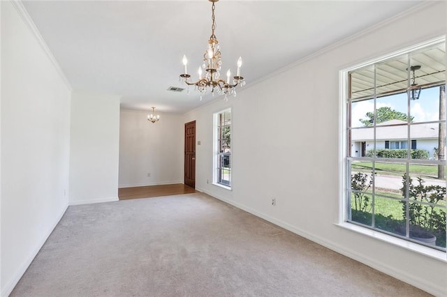 carpeted empty room with ornamental molding and a wealth of natural light