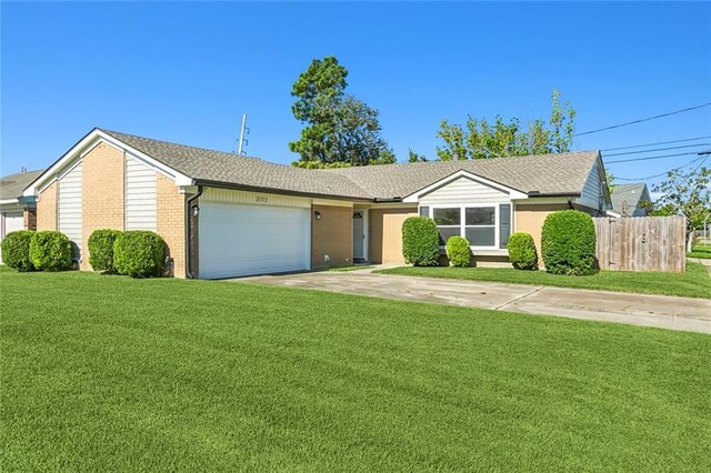 single story home with a front yard and a garage