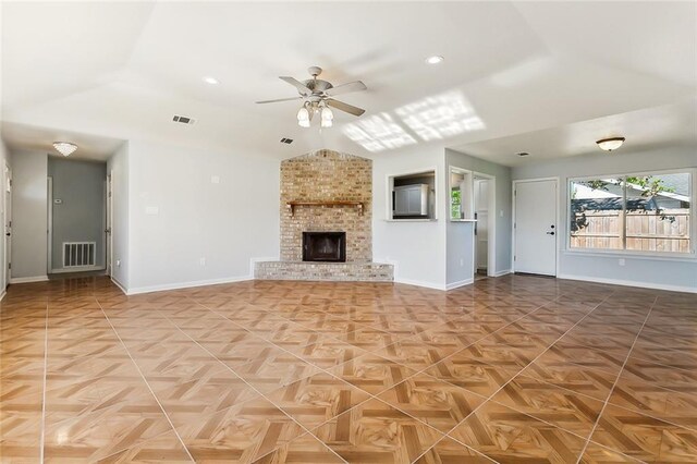 unfurnished living room with lofted ceiling, a brick fireplace, parquet floors, and ceiling fan