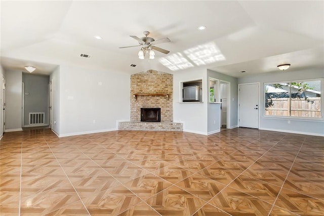 unfurnished living room with baseboards, visible vents, ceiling fan, and a fireplace