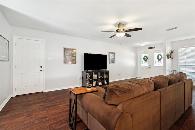 living room with french doors, dark wood-type flooring, and ceiling fan