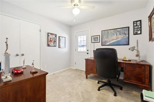 carpeted office space with ceiling fan