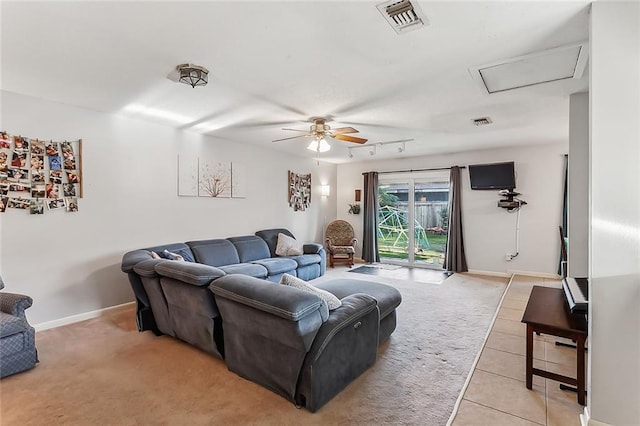 tiled living room featuring rail lighting and ceiling fan