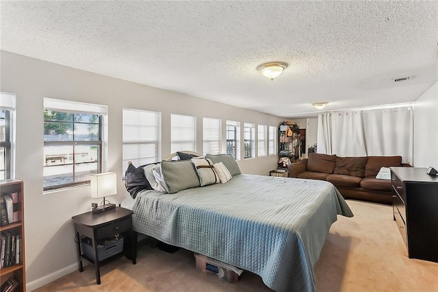 carpeted bedroom with a textured ceiling