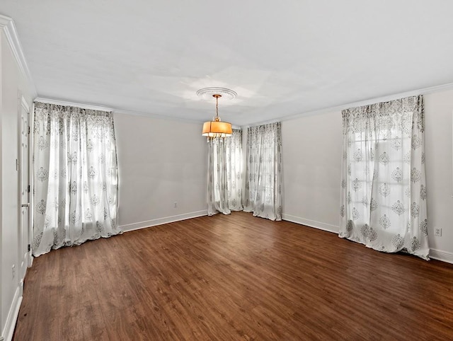 empty room featuring ornamental molding, a notable chandelier, dark hardwood / wood-style floors, and plenty of natural light