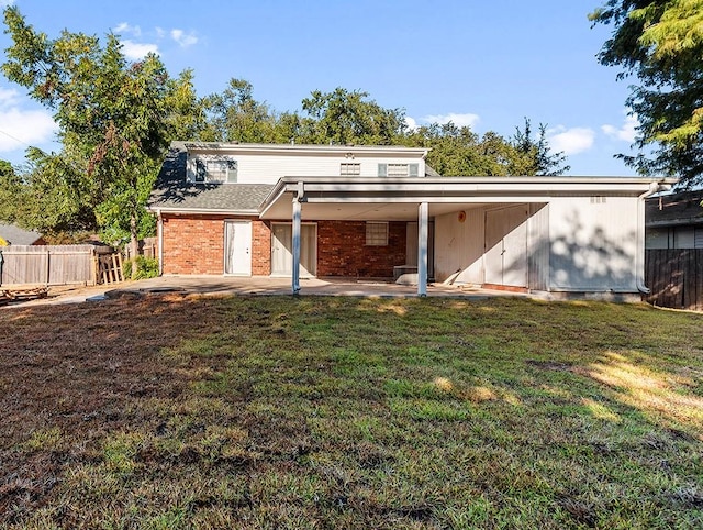 back of property with a patio area and a lawn