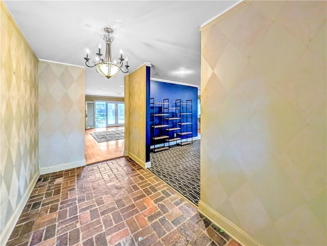 corridor featuring an inviting chandelier and crown molding